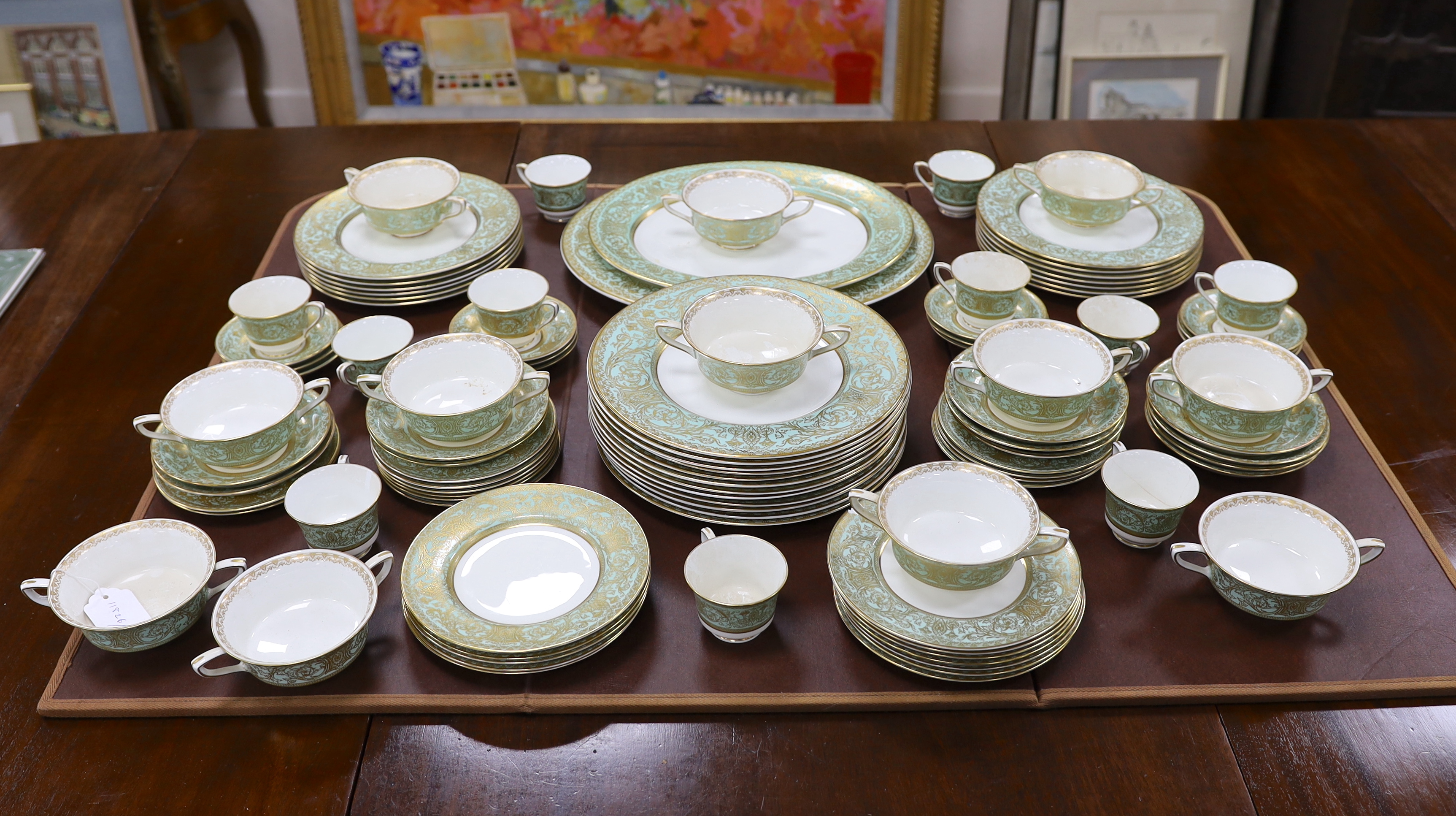 A Royal Worcester green and gilt decorated part dinner service